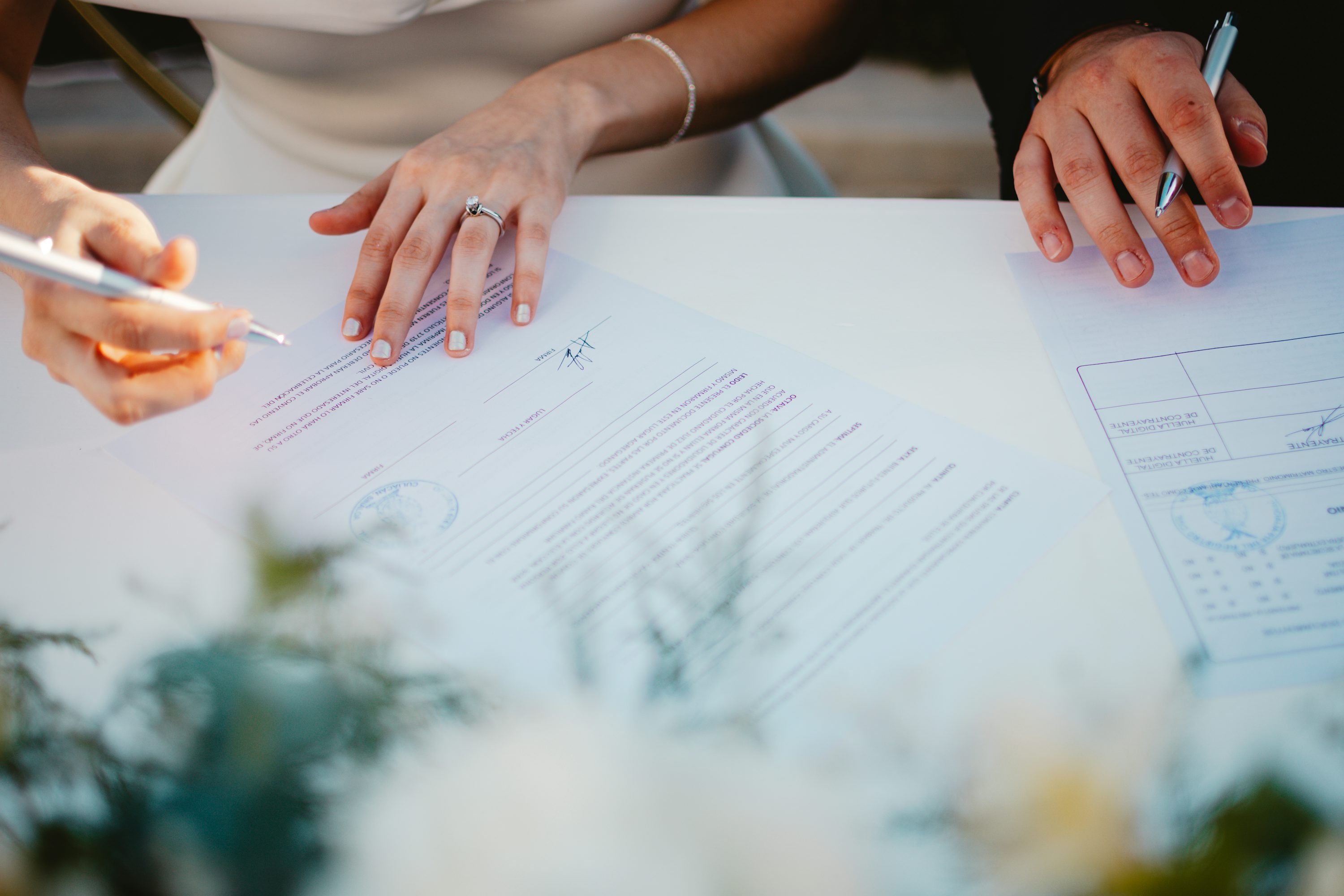 A couple signing financial planning documents together